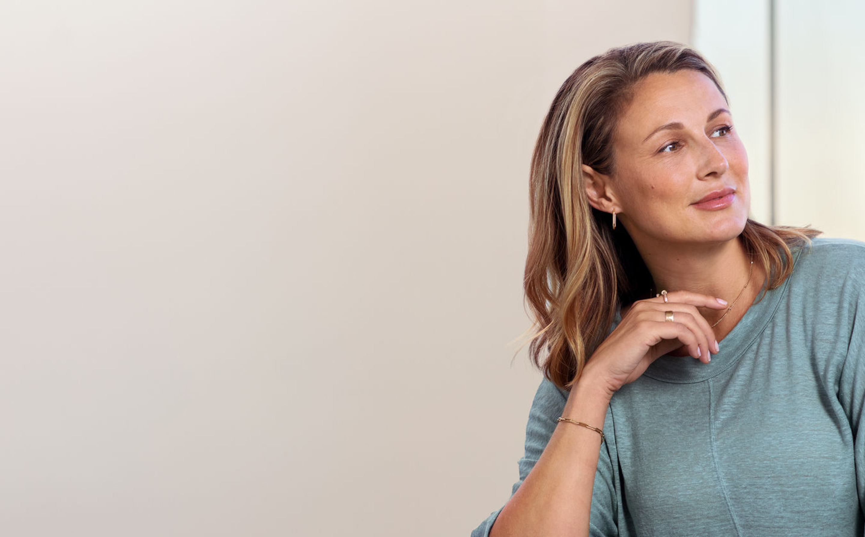 Actual JUVÉDERM® patient smiling looking away from camera